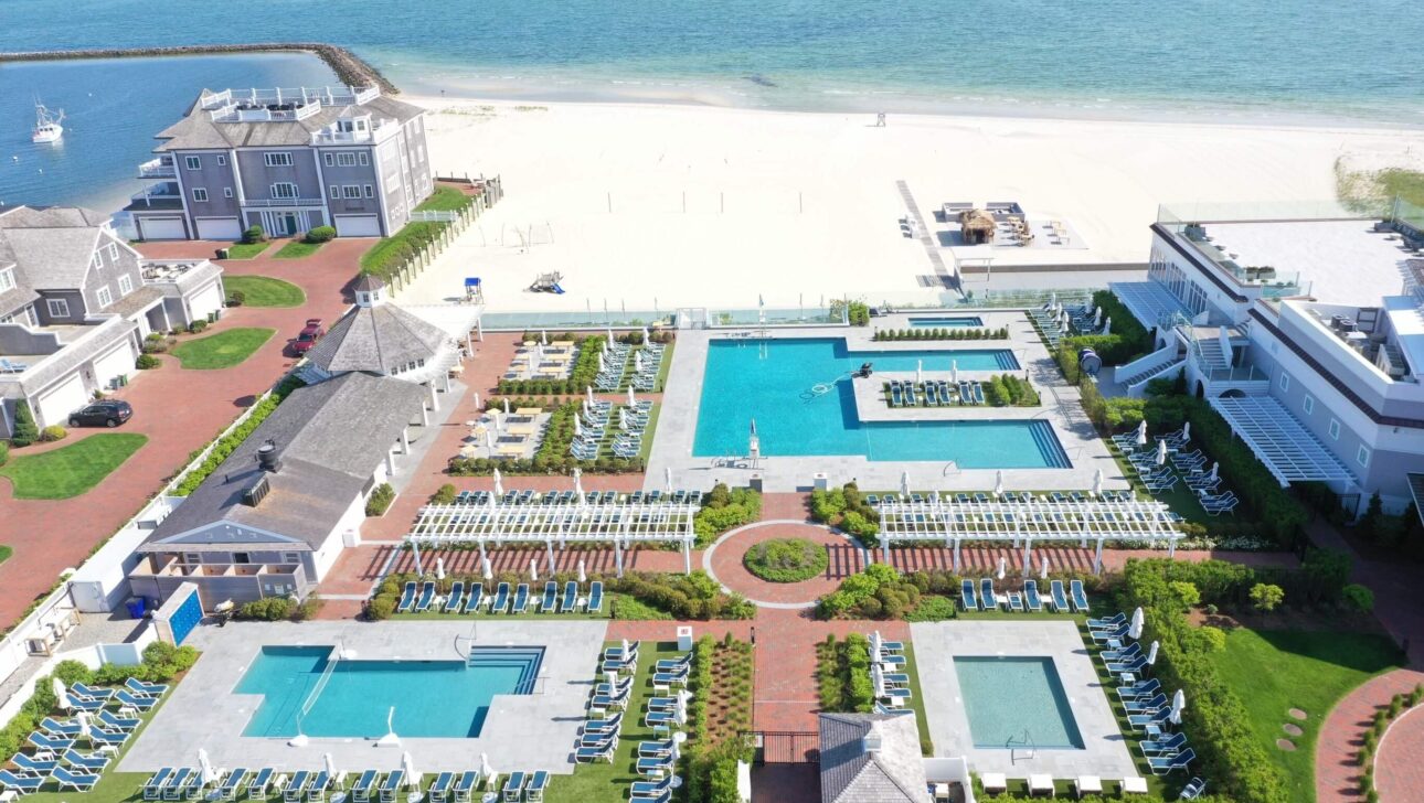 aerial shot of the beach club and pools by the beach.