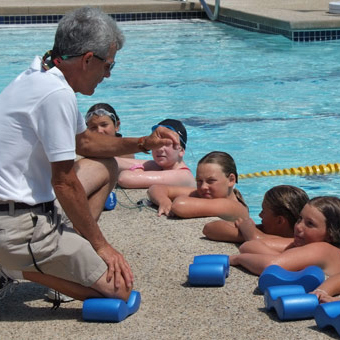 A swim instructor and students.