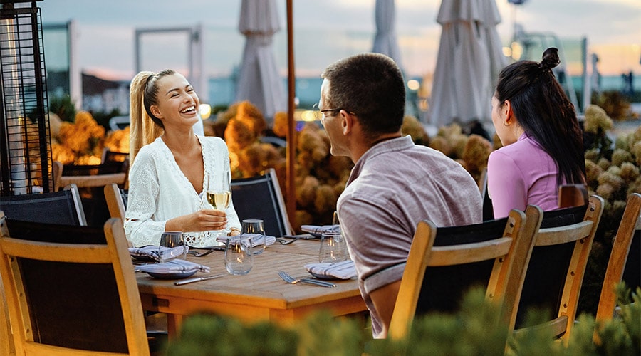 Friends enjoying waterfront dinner
