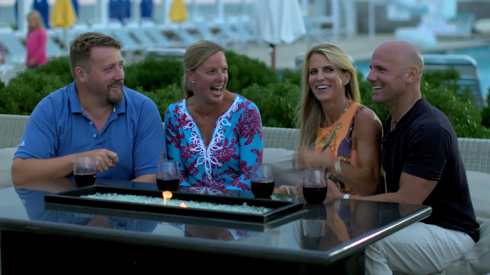 four people dining at a beach club.